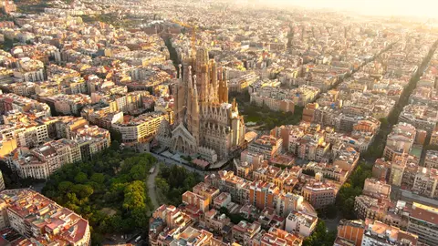 Vue aérienne de la Sagrada Família au lever du soleil, au cœur du quadrillage de l'Eixample à Barcelone